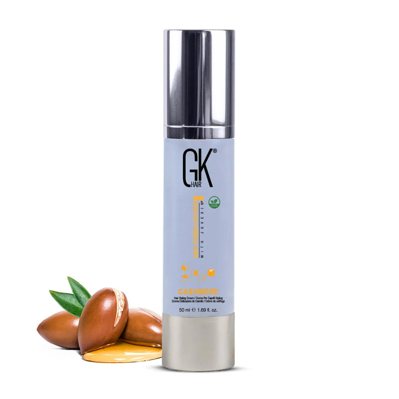 GK Hair Cashmere Hair Cream 50 ml pale blue pump bottle beside argan nuts and oil on a white background