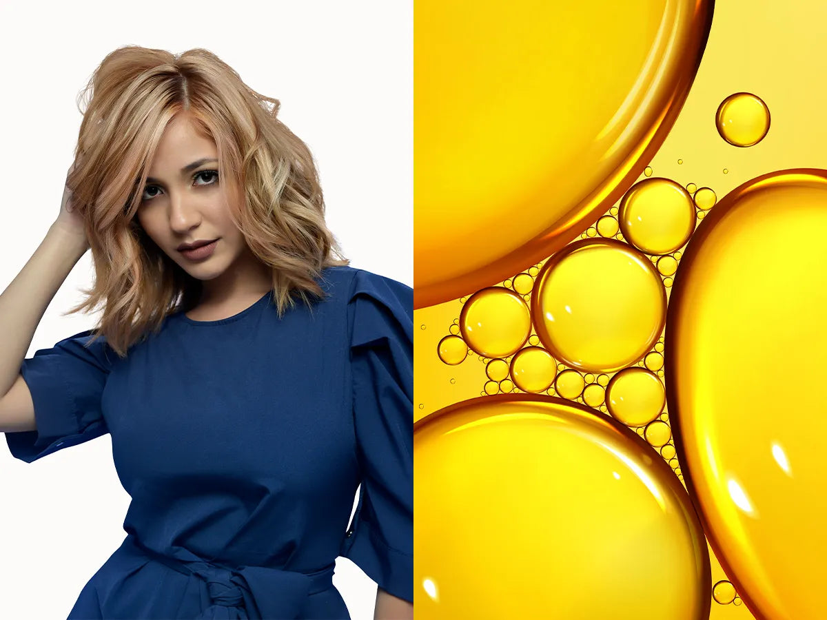 A woman with wavy, strawberry blonde hair wearing a blue dress poses confidently. Beside her, vibrant yellow oil bubbles of varying sizes.