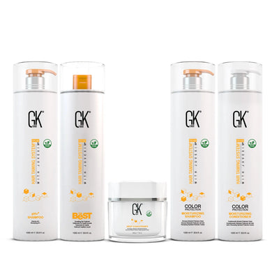 Five hair care products from GK Hair, including moisturing shampoo, conditioner, the best hair treatment  and a deep conditioner, all in sleek white containers with gold accents.
