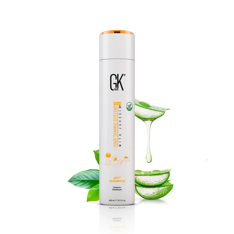 GK Hair pH+ Shampoo 300 ml bottle with orange cap beside sliced aloe vera and green leaves on a white background